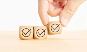 hand moving wooden blocks with check marks